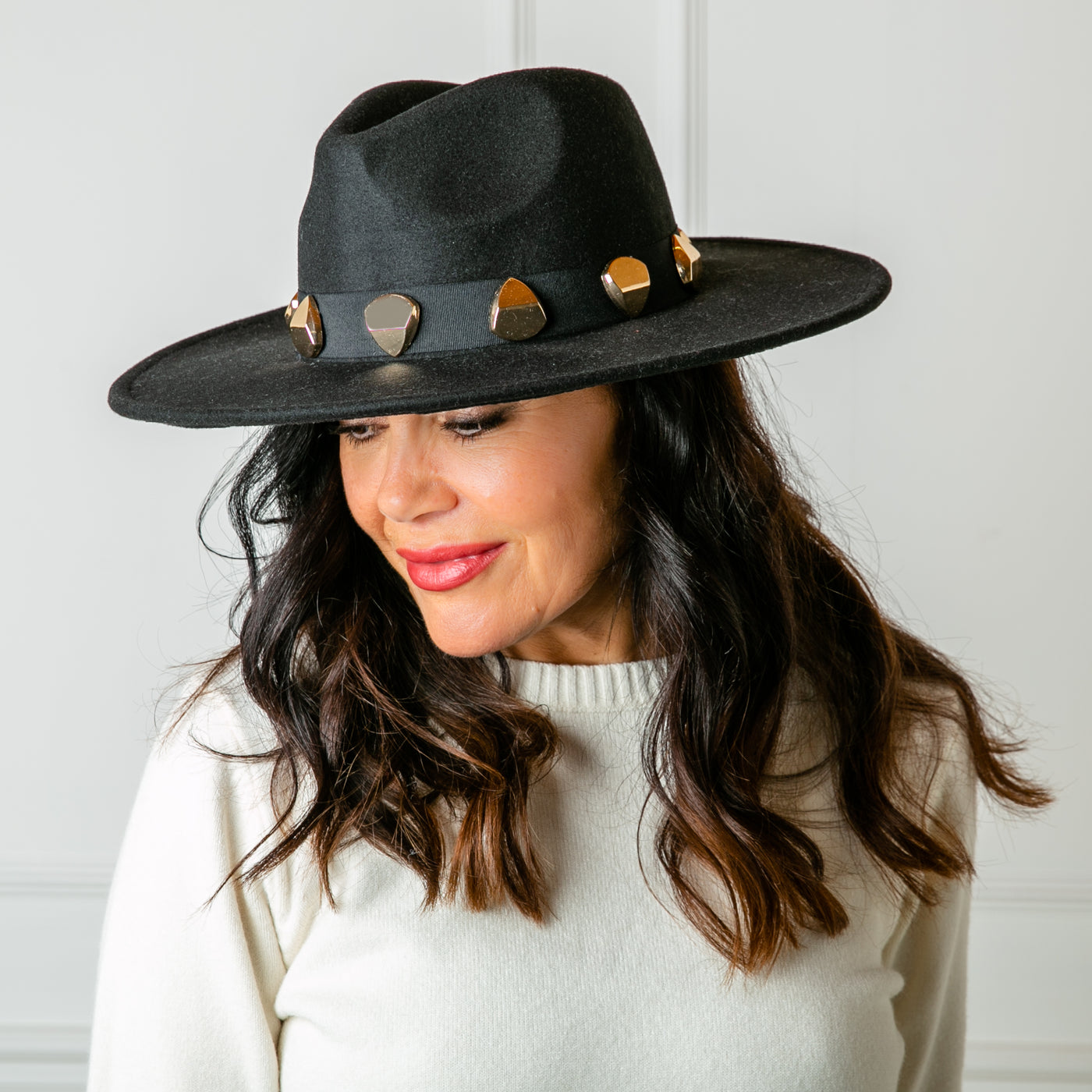 The black Fedora Hat, made from a felted material for a structured look, perfect for making a statement